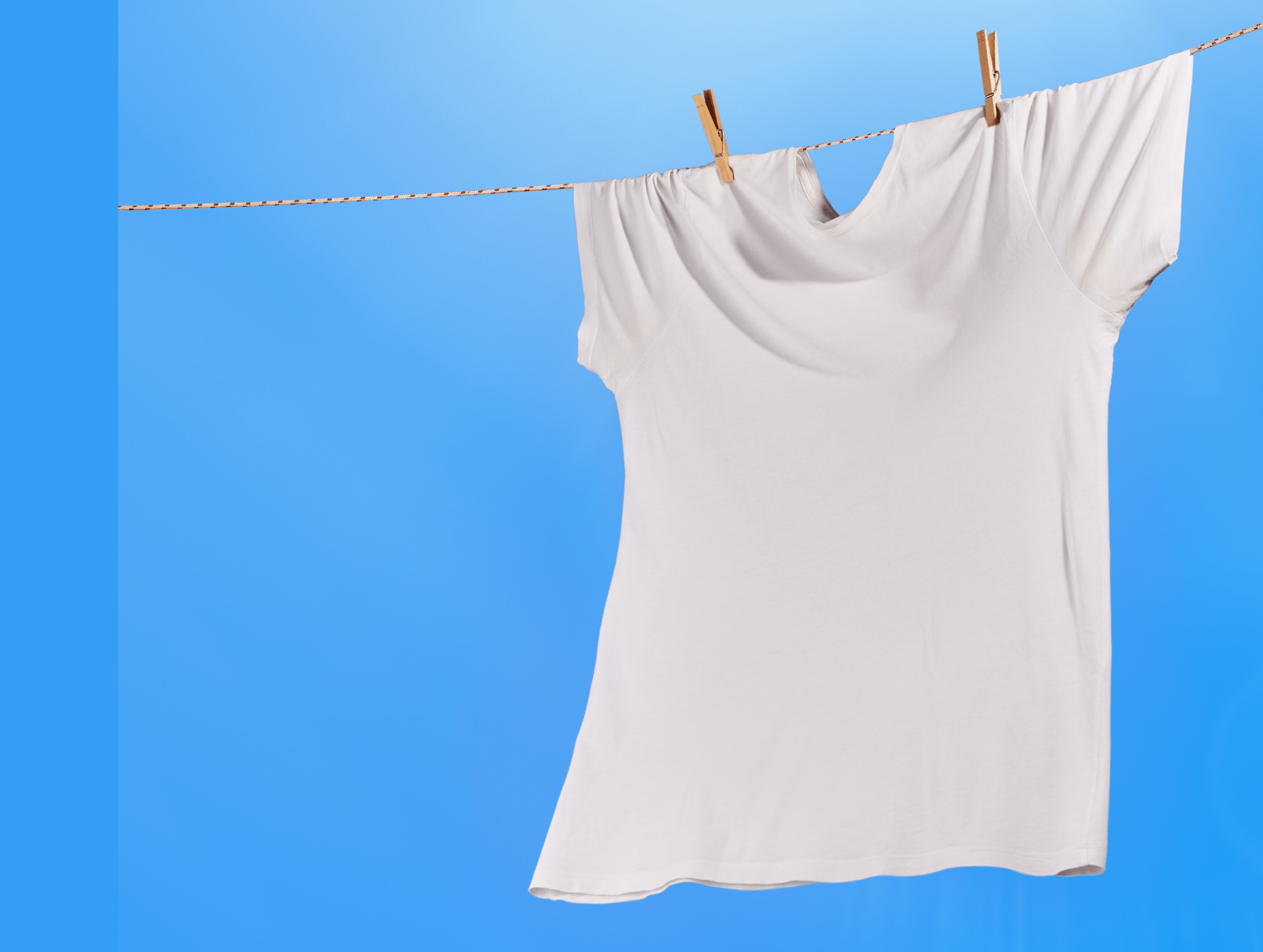 T-shirt on a clothesline dryning in a sunny summer day with clear blue sky at the background
