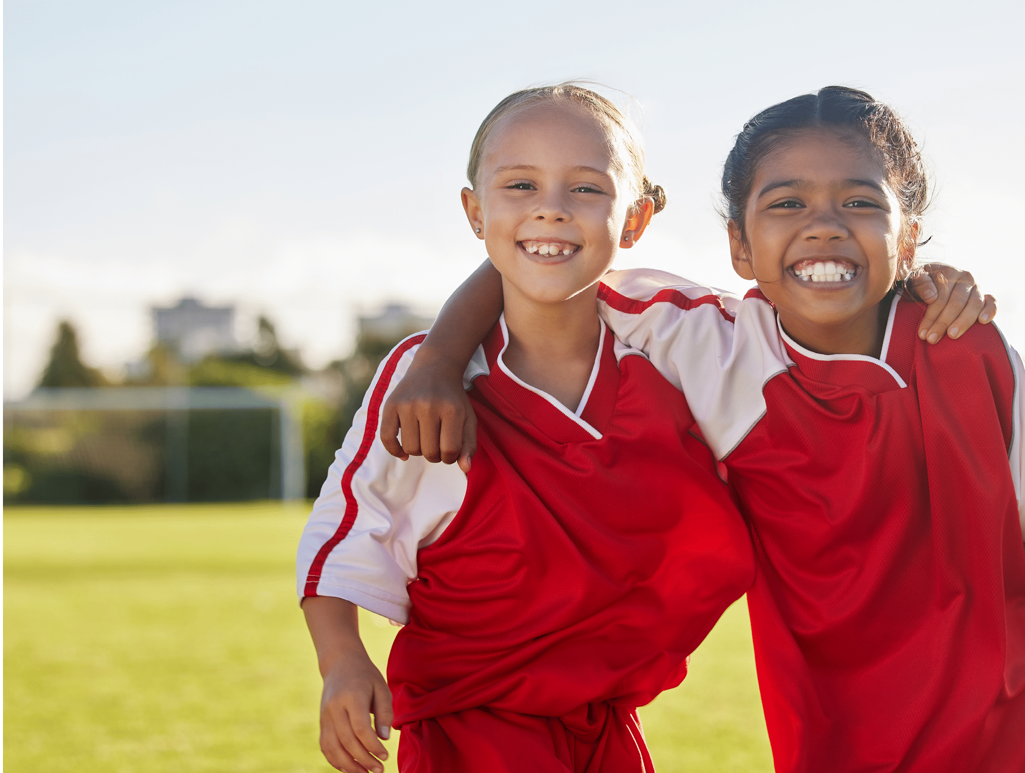 Portrait, girl friends and smile on football field training for match, game or competition. Soccer, sports and kids on grass pitch learning ball sport for wellness, health and fitness exercise.