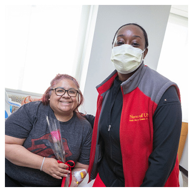 From L:R Nikesha Raymond, RN (Infusion), Mother’s Day Tradition Continues with Rose Deliveries for 2025,In honor of Mother’s Day, the ambulatory infusion teams distributed roses to patients who visited USC Norris Cancer Day Hospital, the Norris Healthcare Center Treatment Center and Women’s Specialty Care Clinic, as well as Keck Medicine of USC treatment centers in Arcadia, Buena Park, Koreatown, Santa Clarita, Newport Beach and Pasadena during the week of Mother’s Day.,This has become an annual tradition to celebrate patients who are mothers coming to Keck Medicine of USC for chemotherapy and infusion treatments.,“This long-standing tradition is an important way to honor the many mothers who receive treatment from us,” said Smitha Ravipudi, MPH, CEO for USC Care Medical Group and Ambulatory Services. “These courageous individuals are a true inspiration to our health system, and their strength, resilience, and generosity motivate us to aim higher in our everyday lives.”
