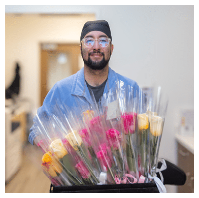 Mark Marquez (Certified Medical Asst.)holding the delivered roses to share with patients. Mother’s Day Tradition Continues with Rose Deliveries for 2025,In honor of Mother’s Day, the ambulatory infusion teams distributed roses to patients who visited USC Norris Cancer Day Hospital, the Norris Healthcare Center Treatment Center and Women’s Specialty Care Clinic, as well as Keck Medicine of USC treatment centers in Arcadia, Buena Park, Koreatown, Santa Clarita, Newport Beach and Pasadena during the week of Mother’s Day.,This has become an annual tradition to celebrate patients who are mothers coming to Keck Medicine of USC for chemotherapy and infusion treatments.,“This long-standing tradition is an important way to honor the many mothers who receive treatment from us,” said Smitha Ravipudi, MPH, CEO for USC Care Medical Group and Ambulatory Services. “These courageous individuals are a true inspiration to our health system, and their strength, resilience, and generosity motivate us to aim higher in our everyday lives.”