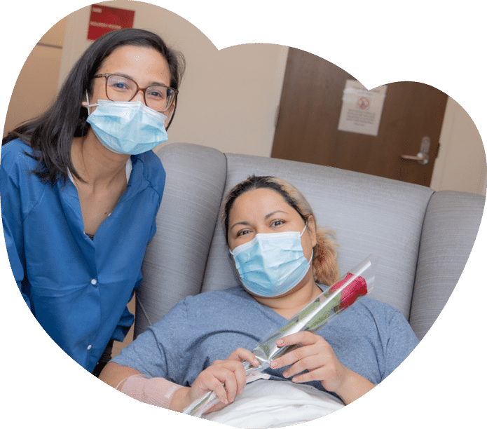 Crystal Madrid receives a rose from nurse Pamela French - Mother's Day Roses 2022 - HC3 Keck Medicine of USC